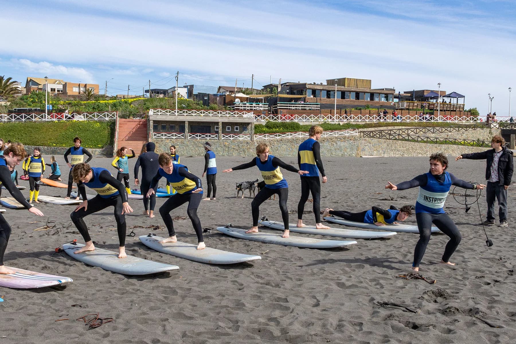 Alumnos practicando con un instructor en la playa